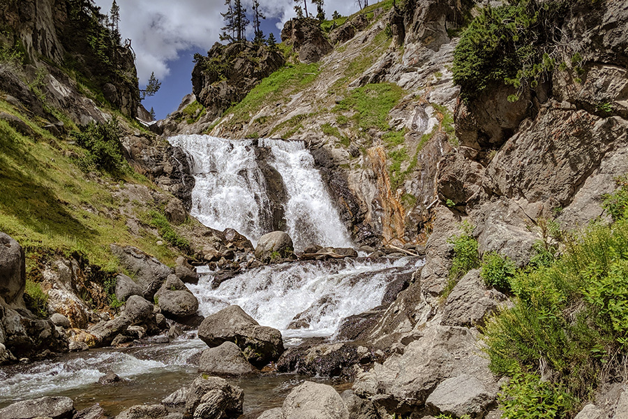 Mountain waterfall cascading over steep rocky terrain